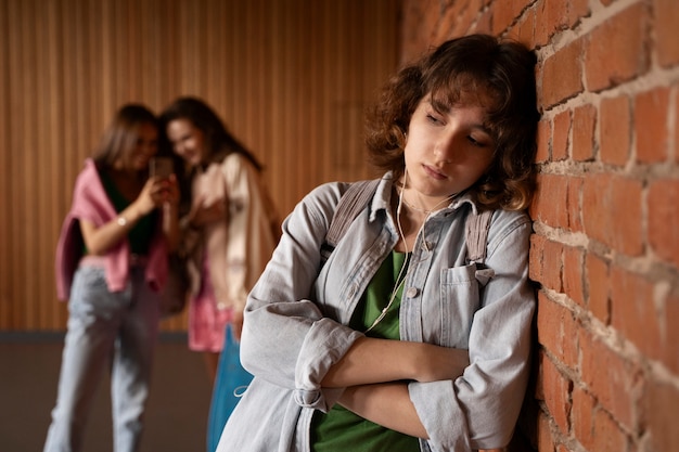 Front view sad girl being bullied at school