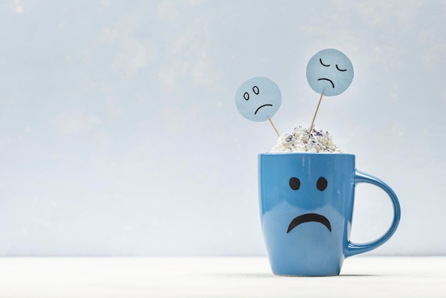 Free photo front view of sad mug for blue monday with copy space