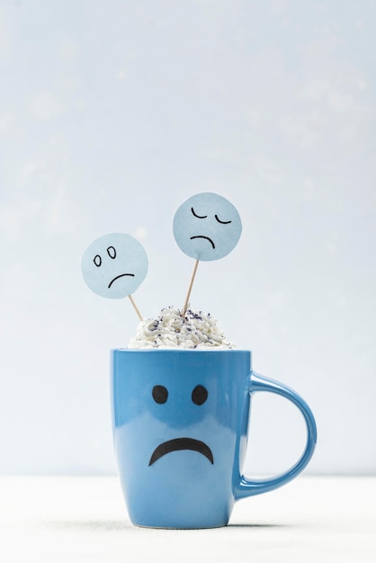 Free photo front view of sad mug with copy space for blue monday