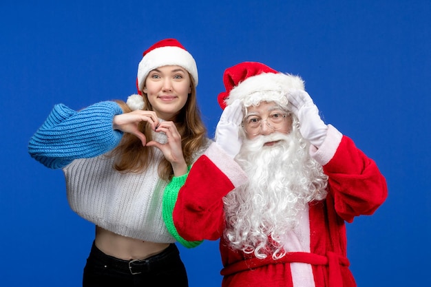 Front view santa claus along with young female on blue holidays human christmas color new year