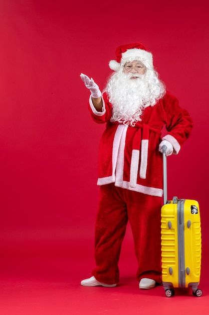 Free Photo front view santa claus carrying yellow bag preparing for trip