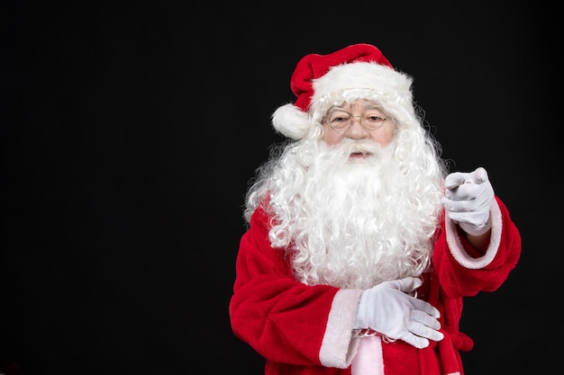 Free photo front view santa claus in classic red suit with white beard