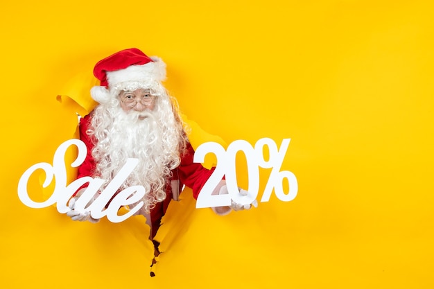 Free photo front view santa claus holding sale and writings