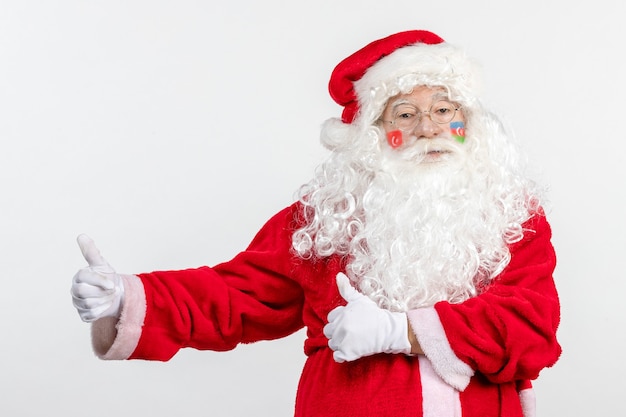 Front view of santa claus with azerbaijani and turkish flag paints on his face on white wall