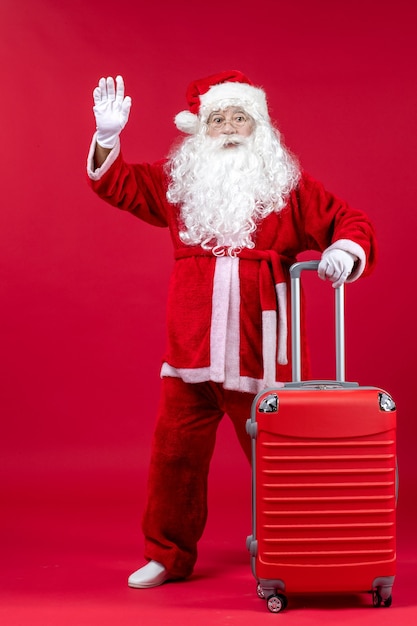 Free photo front view of santa claus with his red bag on red wall