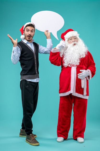 Front view santa claus with young male whos holding white sign on blue background