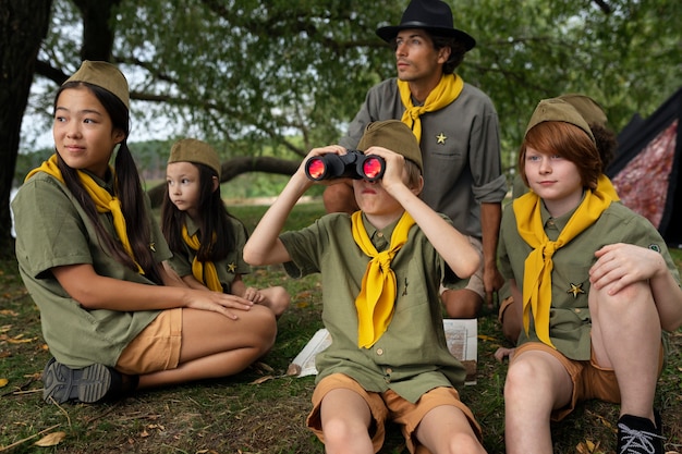 Free photo front view scouts with binoculars