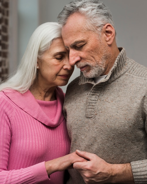 Front view senior couple holding hands