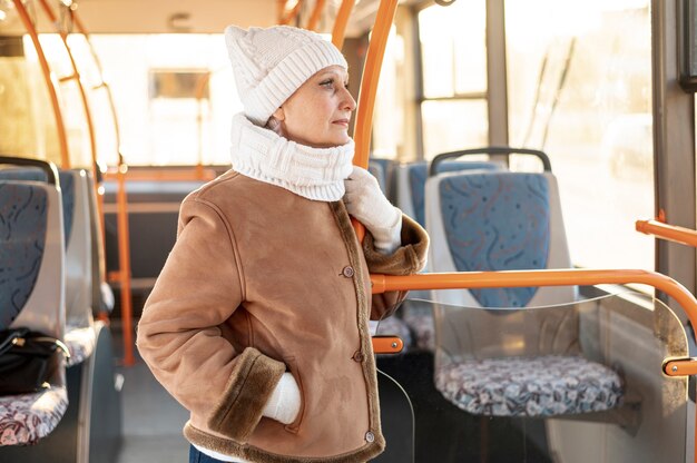 Front view senior female riding bus