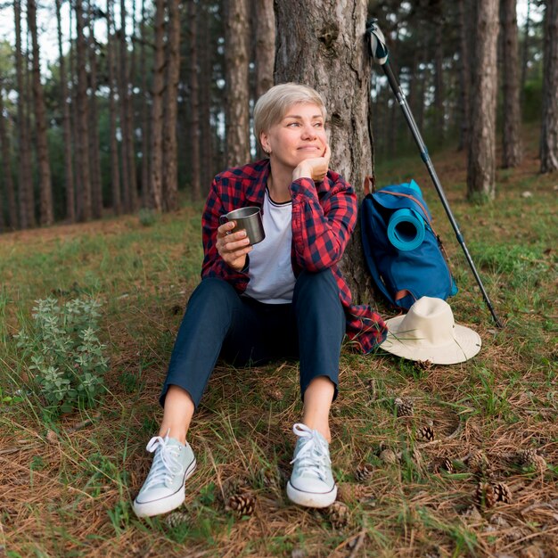 Front view of senior tourist woman relaxing outdoors