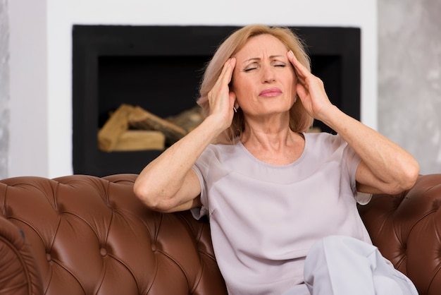 Free Photo front view senior woman having a terrible headache