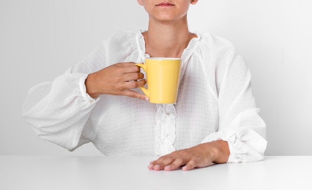 Free Photo front view serious person holding a mug