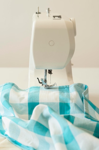 Free Photo front view of sewing machine and textile