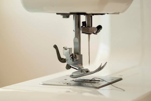 Free photo front view of sewing machine with needle