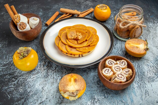 Front view of sliced persimmon on pancake on light surface