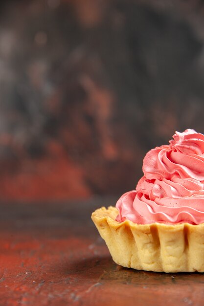 Front view small tart with pink pastry cream on dark red table copy space