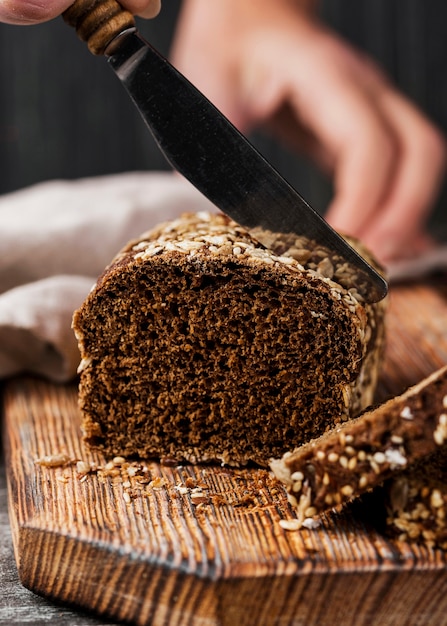 Front view small whole-grain bread on wooden board