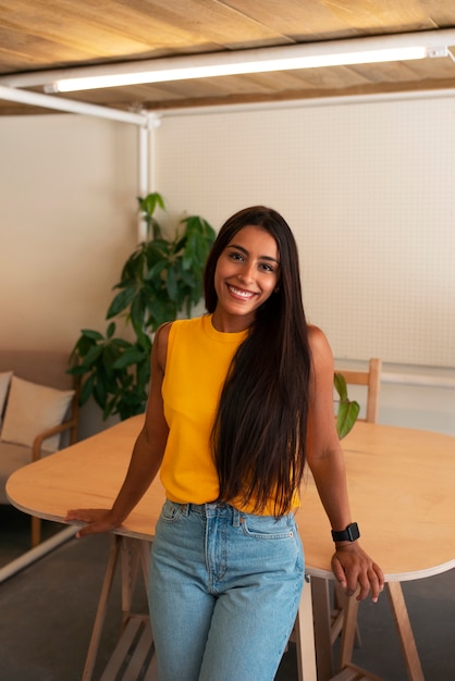 Free photo front view smiley arab woman posing indoors