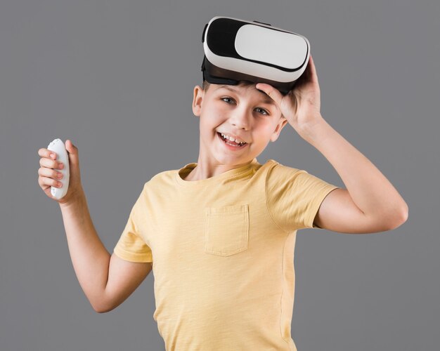 Front view of smiley boy wearing virtual reality headset