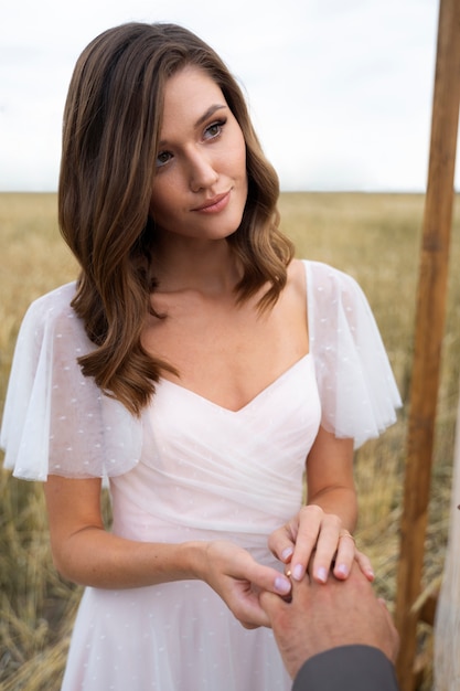 Free photo front view smiley bride outdoors