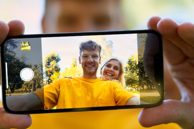 Front view smiley couple taking selfie