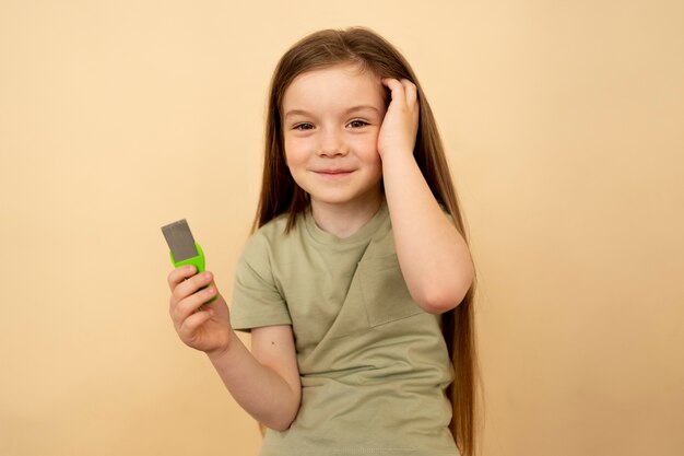 Front view smiley girl holding comb