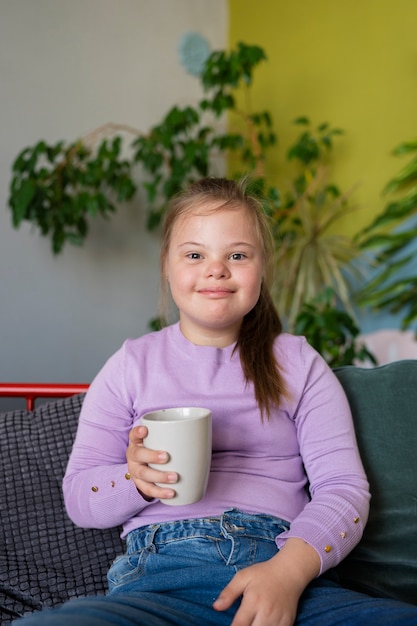 Free photo front view smiley girl holding cup