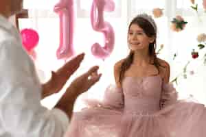 Free photo front view smiley girl wearing pink dress