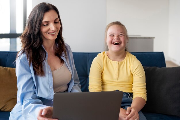 Front view smiley girl and woman indoors