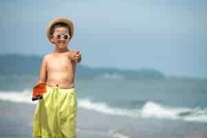 Free photo front view smiley kid on beach