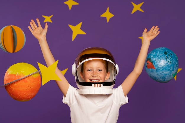 Free photo front view smiley kid posing indoors