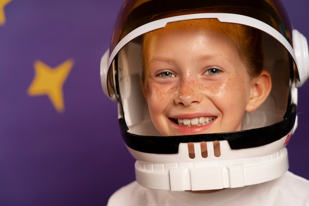 Free photo front view smiley kid wearing helmet