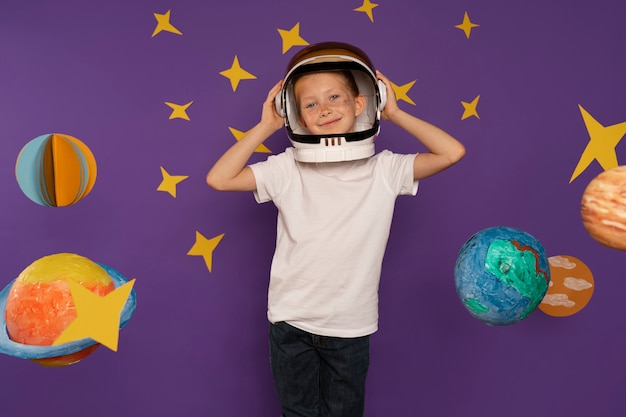 Free photo front view smiley kid wearing helmet