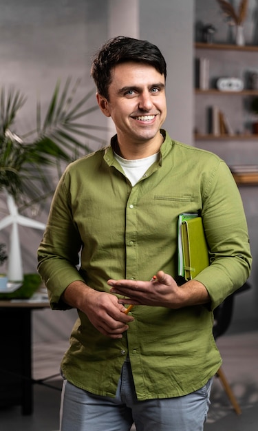 Front view of smiley man next to an eco-friendly wind power project layout