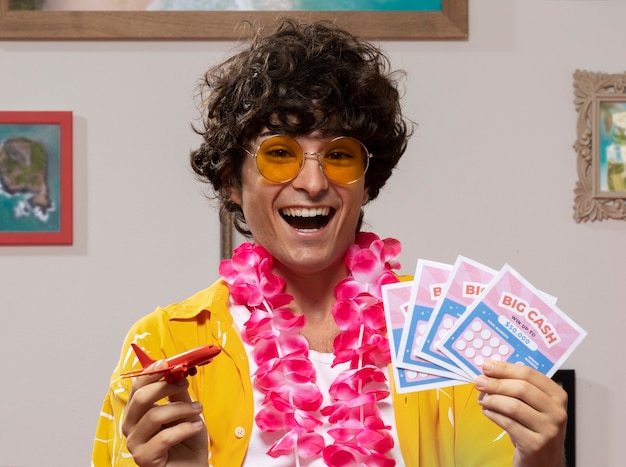 Free Photo front view smiley man holding lottery tickets