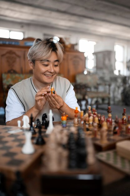 Front view smiley man playing chess