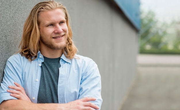 Front view of smiley man posing outdoors