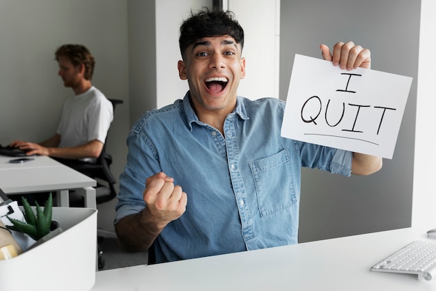 Free photo front view smiley man quitting job