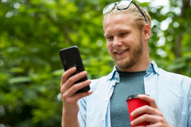 Front view of smiley man talking on phone