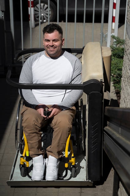 Free photo front view smiley man in wheelchair