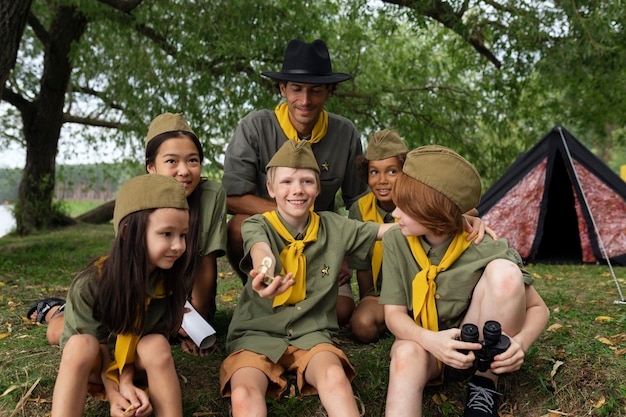 Free photo front view smiley scouts outdoors