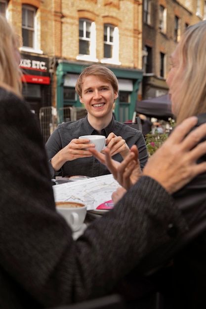 Front view smiley teen sitting at table