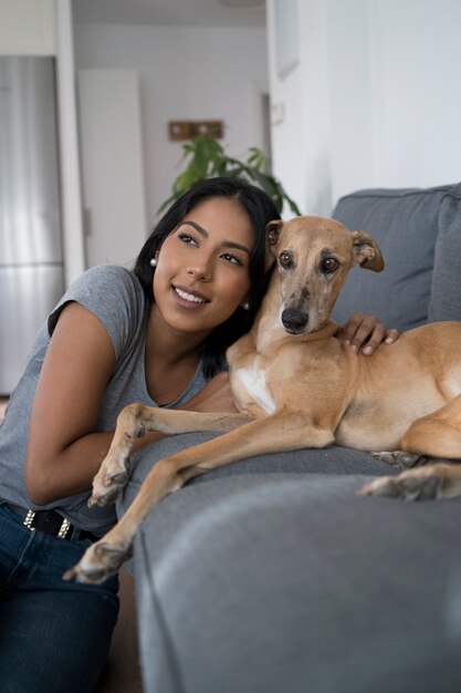 Front view smiley woman and dog at home