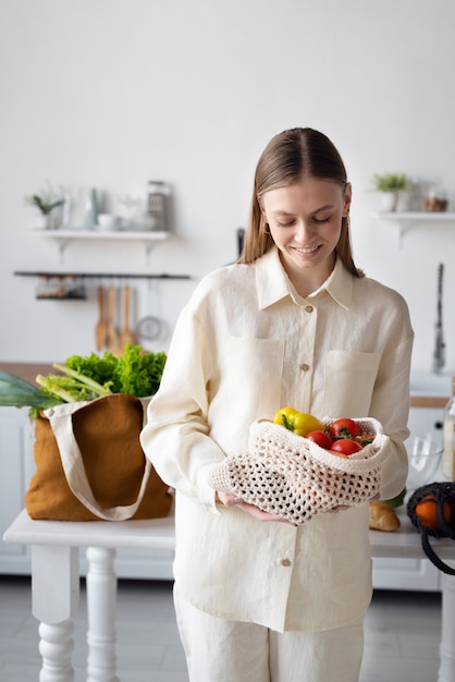 Free photo front view smiley woman holding bag