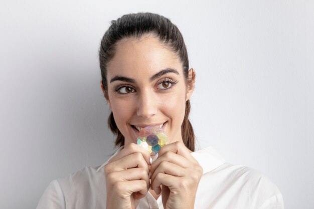 Front view of smiley woman holding diamond