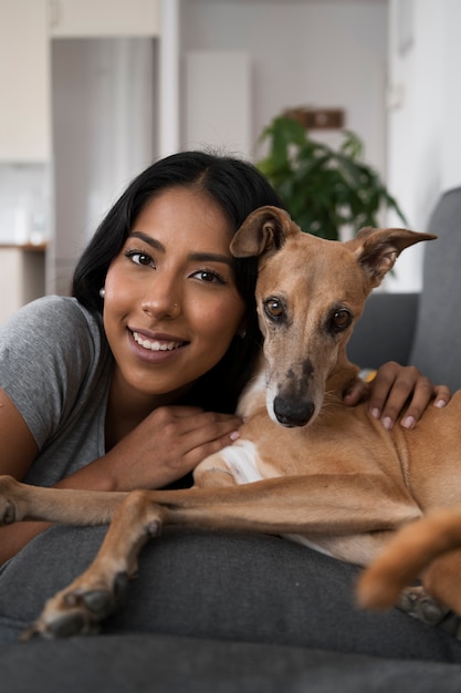 Front view smiley woman holding dog