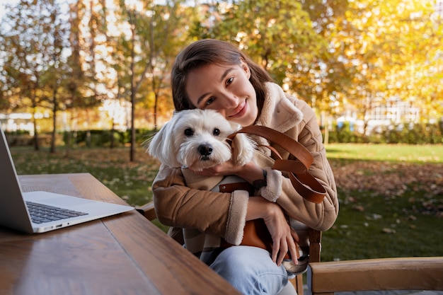 Front view smiley woman holding dog