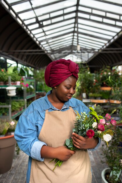 Front view smiley woman holding flowers