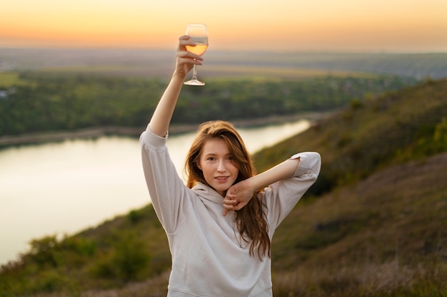 Free photo front view smiley woman holding glass up