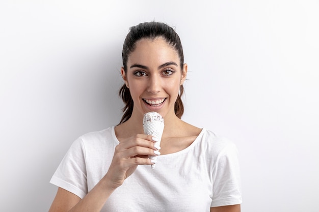 Front view of smiley woman holding ice cream